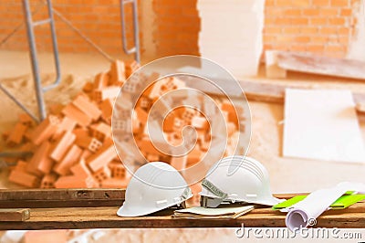 Safety helmet plastic and blueprint on wood with blur construction building site workplace background. with copy space add text Stock Photo