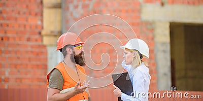 Safety inspector concept. Construction site safety inspection. Discuss progress project. Woman inspector and bearded Stock Photo
