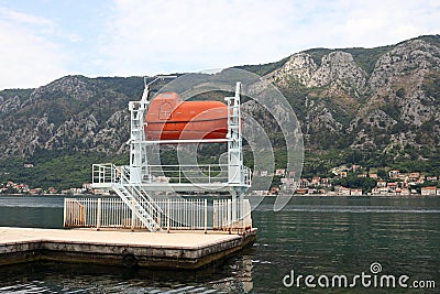 Safety lifeboat on the coast Kotor bay Stock Photo