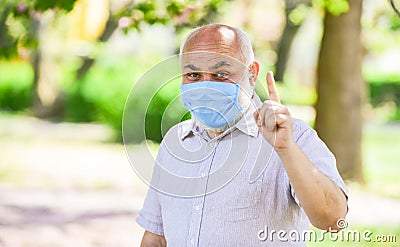 Safety measures. Coronavirus pandemic. Senior man wearing face mask. Pandemic concept. Stop pandemic. Do not touch your Stock Photo
