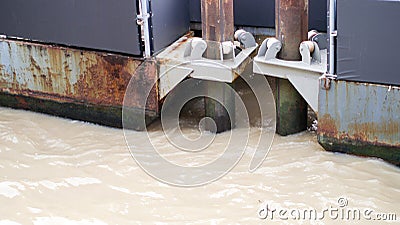 Safety metal steel pier strong post column in wave river Stock Photo