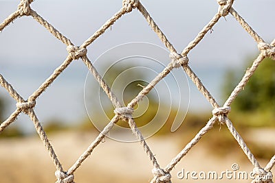 Safety net, fence, woven mesh at the beach Stock Photo