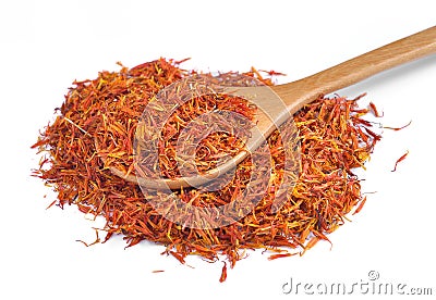 Safflower petals in a spoon on white background Stock Photo