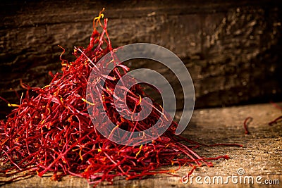 Saffron crocus threads on dark wooden background Stock Photo