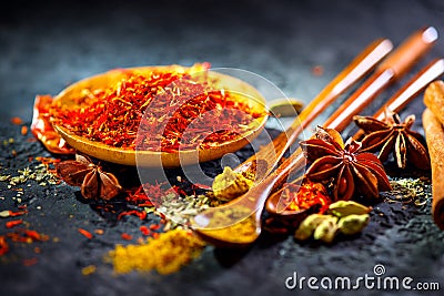 Saffron. Various Indian Spices on black stone table. Spice and herbs on slate background Stock Photo