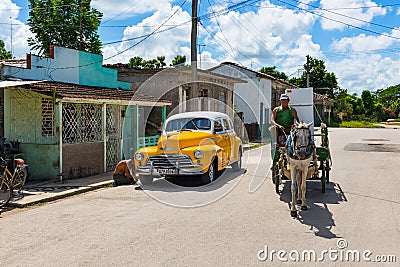 American yellow 1946 Chevrolet Fleetmaster vintage car with white roof parked on the side street in Sagua la Grande Cuba - Serie C Editorial Stock Photo