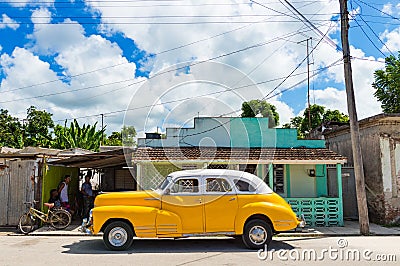 American yellow 1946 Chevrolet Fleetmaster vintage car with white roof parked on the side street in Sagua la Grande Cuba - Serie C Editorial Stock Photo