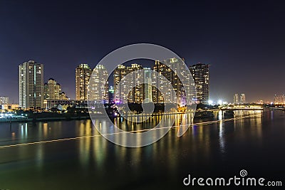 SAIGON, VIETNAM - DEC 27, 2016 - Night on the Saigon River, across the river is Saigon Pearl luxury apartment and a big constructi Editorial Stock Photo