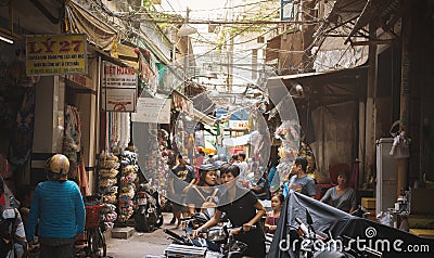Saigon, Vietnam - June 2017: people shopping in crowded lane on asian market, Saigon, Vietnam. Editorial Stock Photo