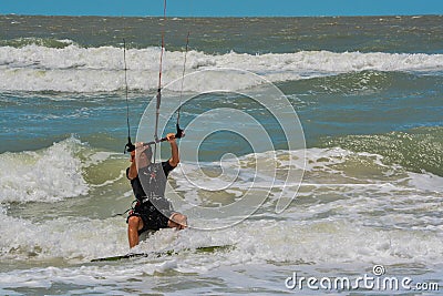 A sail boarder navigating the surf on the Gulf of Mexico in Indian Rocks Beach, Florida Editorial Stock Photo