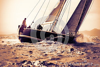 Sail boat sailing on sunset Stock Photo
