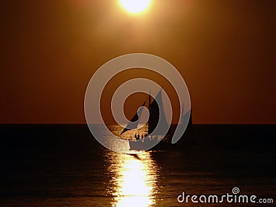 Sail boat at sunset Stock Photo