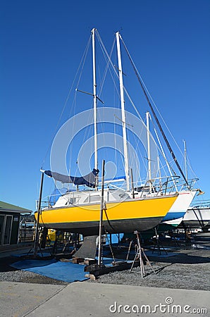 Sail yachts beached at a dock for painting, repair and maintenance Stock Photo