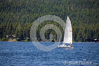 Sailboat on the blue water of a lake Editorial Stock Photo