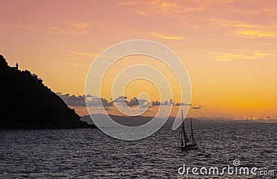 Sailboat on the coast of the city of Donostia with the last rays of the sun at sunset, Cantabrico Sea. Stock Photo