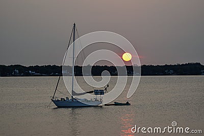 Sailboat crossing the river under the moonlight Editorial Stock Photo