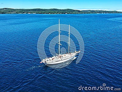 Sailboat gliding across a peaceful body of water Stock Photo