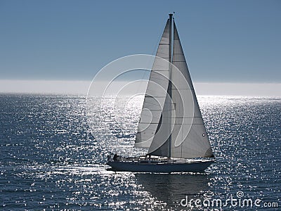 Sailboat gliding on calm sea Stock Photo