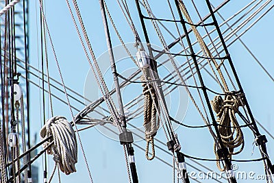 Sailboat masts, rigging and rolled up sails Stock Photo