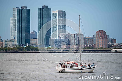 A sailboat in New York harbor Hudson river Jersey City background Editorial Stock Photo