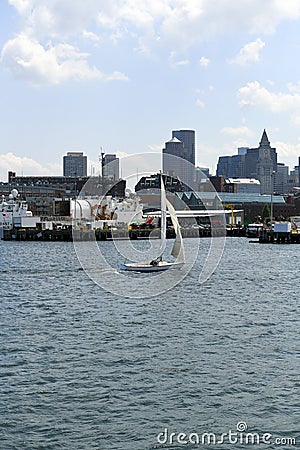 Sailboat passes Coast Guard in Boston Harbor Editorial Stock Photo