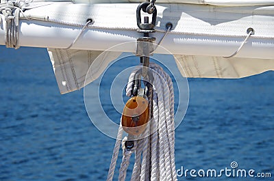 Sailboat sail and wooden rigging ropes against water background Stock Photo