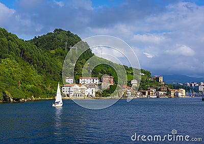 Sailboat sailing in the passages bay, next to Donibane in Gipuzkoa Euskadi Editorial Stock Photo