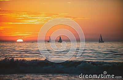 Sailboat at sea. Panoramic view of sunset over ocean. Beautiful serene scene. Sea sky concept, sunrise colors clouds Stock Photo