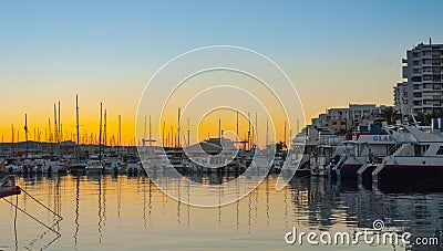 Sailboat silhouettes, magnificent golden warm sunset in Ibiza marina. Editorial Stock Photo