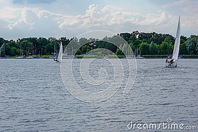 Sailing boat on a calm lake with reflection in the water. Serene scene landscape. Horizontal photograph. Stock Photo
