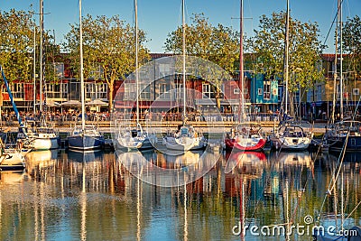 Sailboats and colorful houses of the Gabut district at sunset in the harbor of La Rochelle France Stock Photo