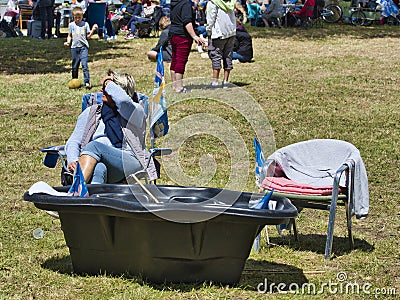 Sailboats fans enjoy big outdoor entertainment event. Open air festival Picnic. Big group of people on grass waiting for armada Editorial Stock Photo