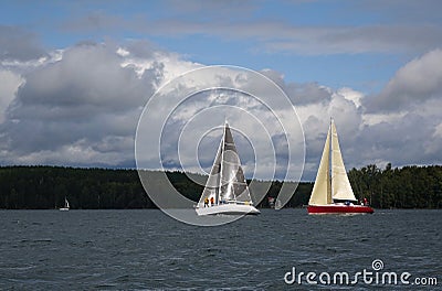 Sailboats floating in blue lake in summer. Stock Photo