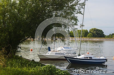 Sailboats floating on lake over the coast Stock Photo