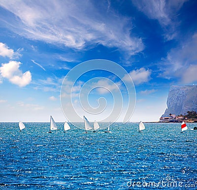 Sailboats Optimist learning to sail in Mediterranean at Denia Stock Photo