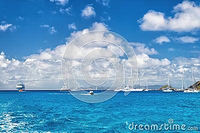 Sailboats, ship and boat sail in blue sea on cloudy sky in gustavia, st.barts. Sailing and yachting adventure. Summer vacation on Stock Photo