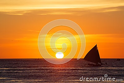 Sailboats at sunset on a tropical sea. Silhouette photo. Stock Photo