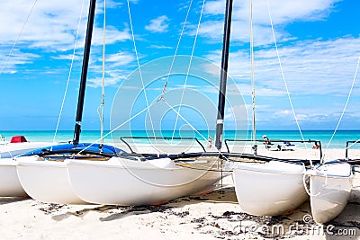 Sailboats on tropical beach during summer day with turquoise water and blue sky. Varadero resort, Cuba. Vacation background Stock Photo