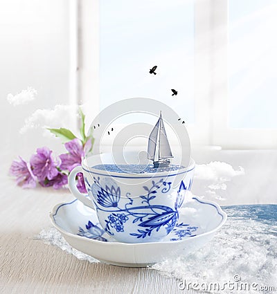 Sailing Boat in a cup of tea with birds Stock Photo