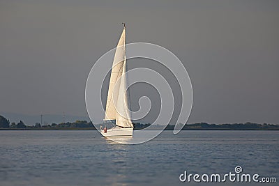 Sailing boat in dusk light Stock Photo