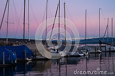 Sailing boat yacht dock pier calm water at dusk Stock Photo