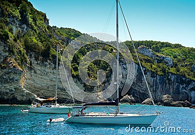 Sailing boats anchored near cliffs Stock Photo