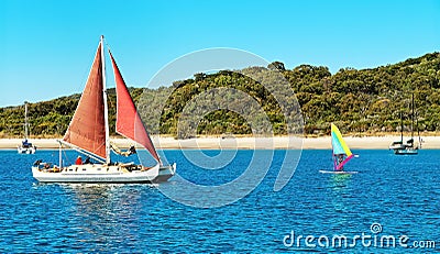 Sailing Catamaran with red sails at Second Beach, Great Keppel Island, Great Barrier Reef, Queensland Stock Photo