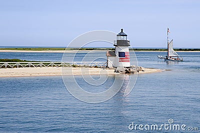 Sailing Past Lighthouse on Nantucket Island on a Summer Day Stock Photo