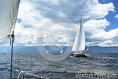 Sailing ship yachts with white sails in sea in stormy weather. Nature. Stock Photo