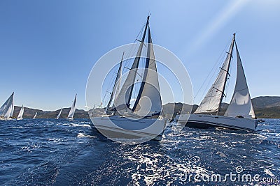 Sailing ships yachts with white sails in the open sea. Stock Photo