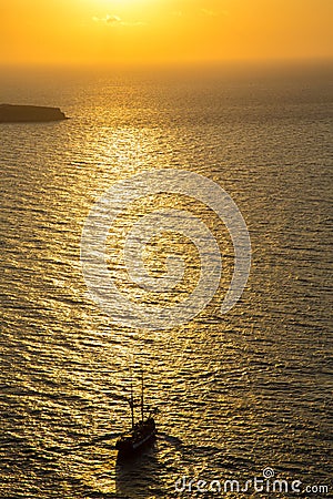 Sailing towards hazy sunset, Santorini, Greece Stock Photo