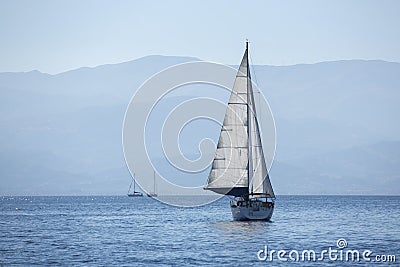 Sailing in the wind through the waves early in the morning Stock Photo