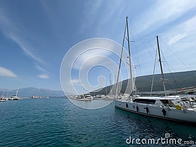 Sailing yachts moored off the mountainous coast Stock Photo