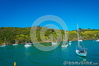 Sailing yachts in Waiheke Island, New Zealand. with a beautiful blue sky and magenta water in a sunny day Stock Photo